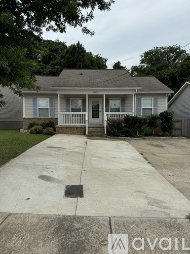 A house with a grey roof and a white front porch.
