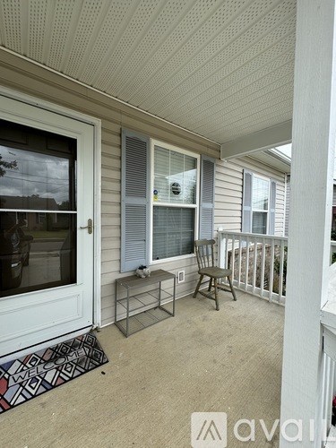 A balcony with a bench and a chair.