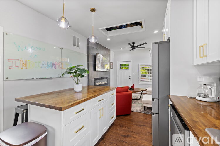 A kitchen with white cabinets and a wooden countertop.