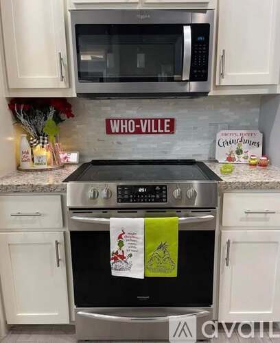 A kitchen with a stove top oven and a microwave above it.