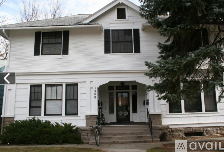 A white house with a black door and windows.