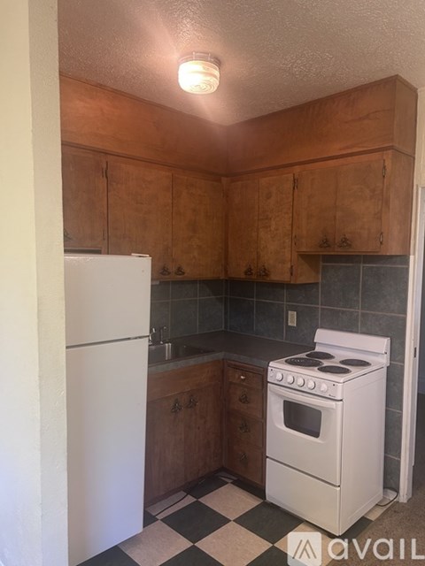 A kitchen with a white fridge and a white stove.