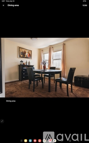 A dining area with a table and chairs.