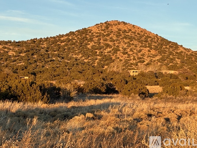 A hill with a small building on top of it.