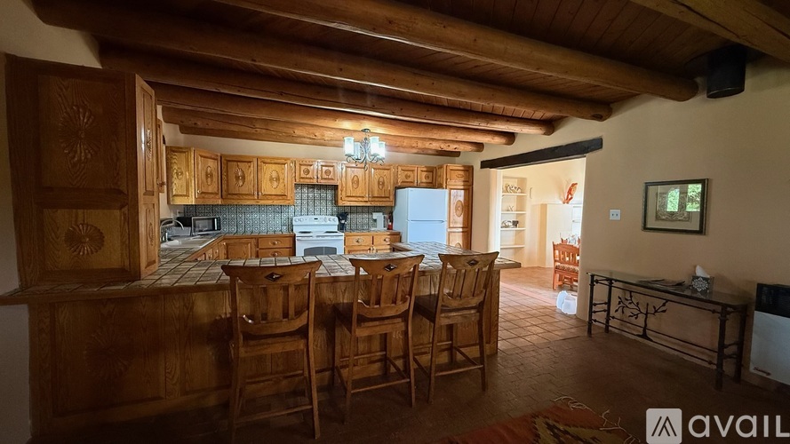 A wooden dining room with a table set for six.