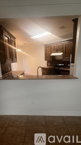 A kitchen with brown cabinets and a white countertop.
