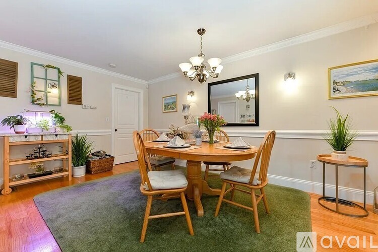 A dining room with a wooden table and chairs.