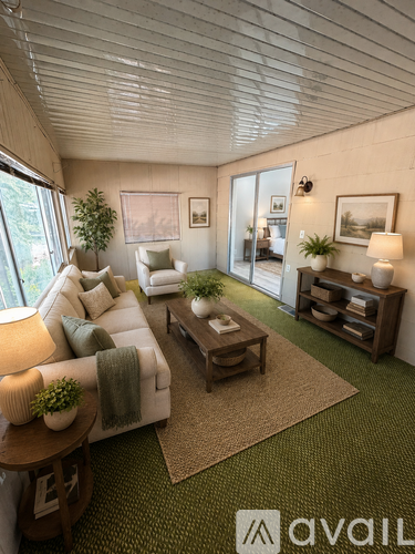 A living room with a white couch, a wooden coffee table, and a rug with the Avail logo on it.