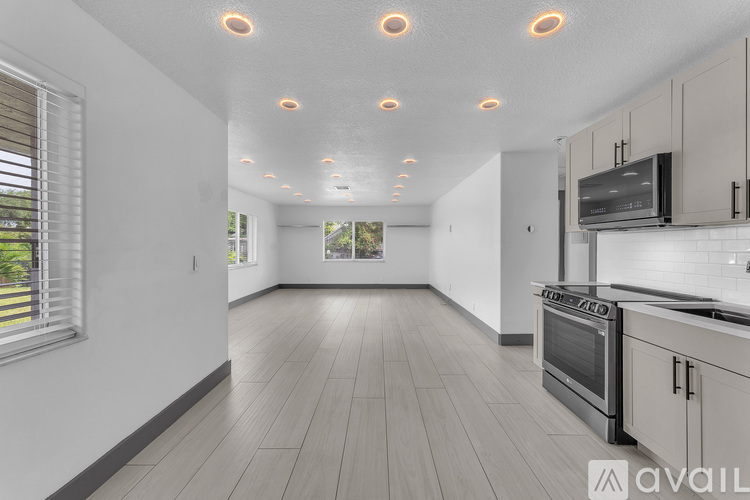 A kitchen with a stove top oven and a microwave.