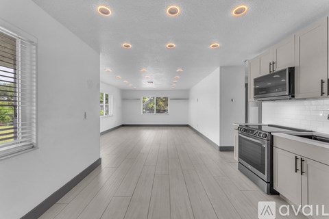A kitchen with a stove top oven and a microwave.