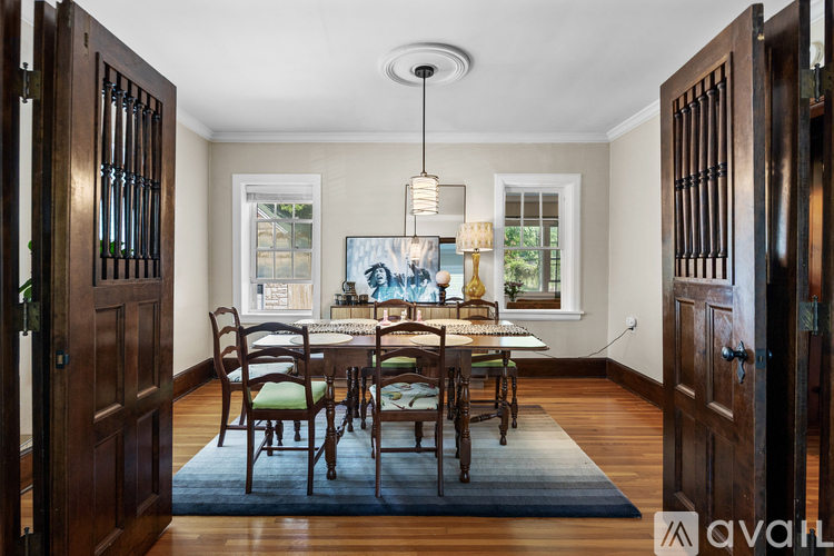 A dining room with a table set for six.