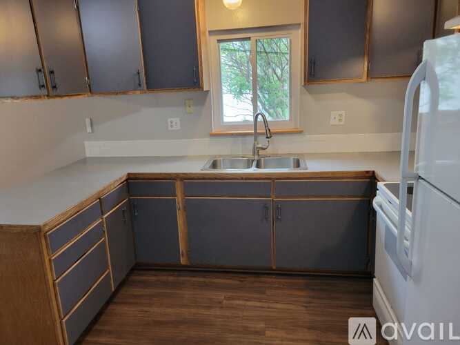 A kitchen with wooden cabinets and a white refrigerator.