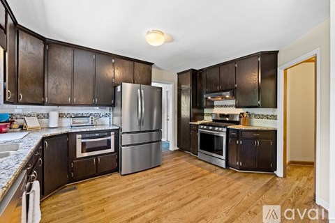 A kitchen with wooden cabinets and stainless steel appliances.
