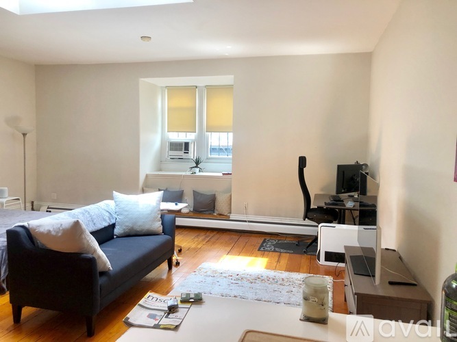 A living room with a blue couch and a television.