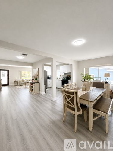 A modern dining room with a wooden table and chairs.