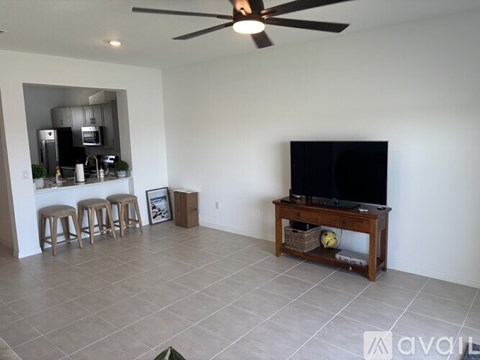 A living room with a television and a bar area.