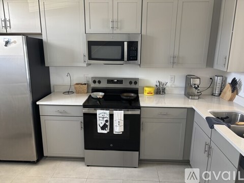 A kitchen with a black dishwasher and a black oven.