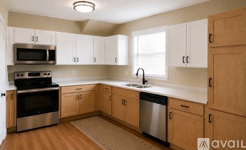 A kitchen with wooden cabinets and stainless steel appliances.