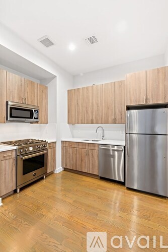 A kitchen with wooden cabinets and stainless steel appliances.