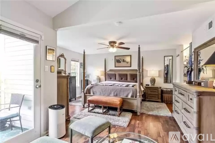A bedroom with a bed, dresser, and mirror.