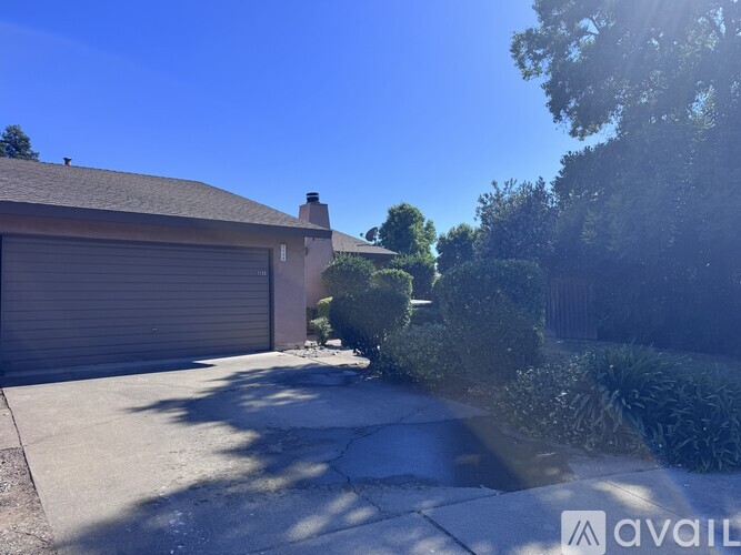 A house with a closed garage door and a driveway.