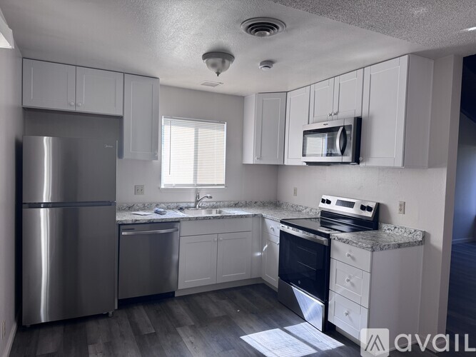 A kitchen with white cabinets and stainless steel appliances.