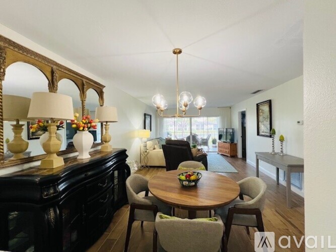A dining room with a wooden table and chairs.