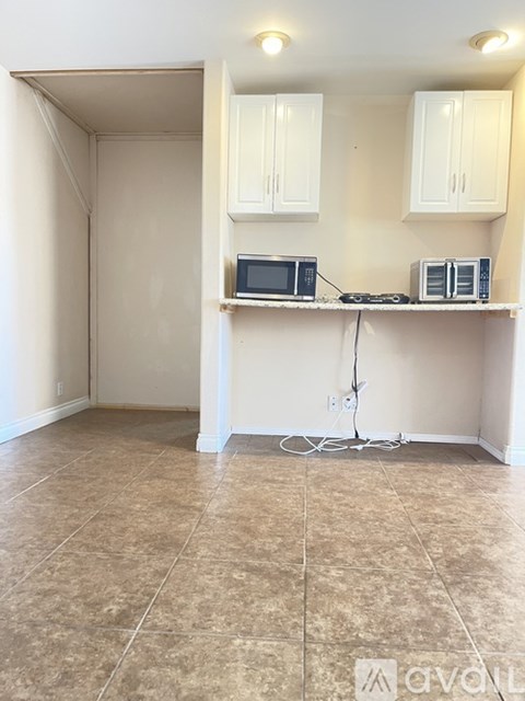 A kitchen area with a microwave and oven on a countertop.