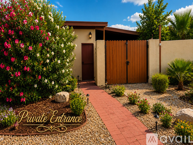 A private entrance sign is on a gravel path leading to a house.