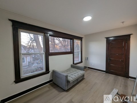 A room with a bed, a window, and a door.