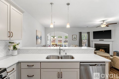 A modern kitchen with a stainless steel dishwasher and a white countertop.