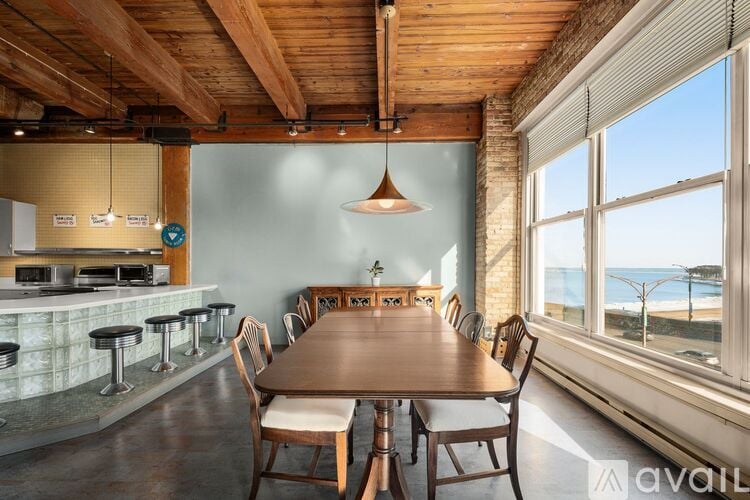A dining area with a long table and chairs.