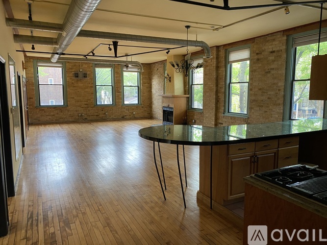 A large open space with a round table and chairs in the center.