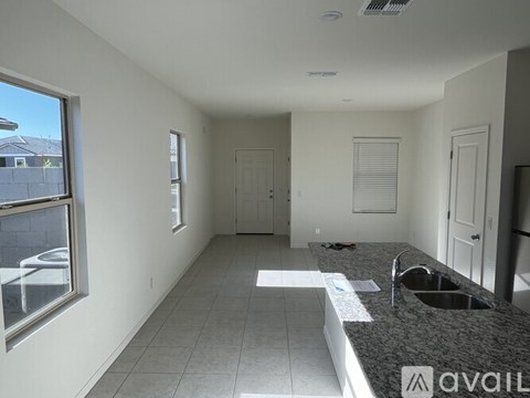 A kitchen with a granite countertop and a sink.