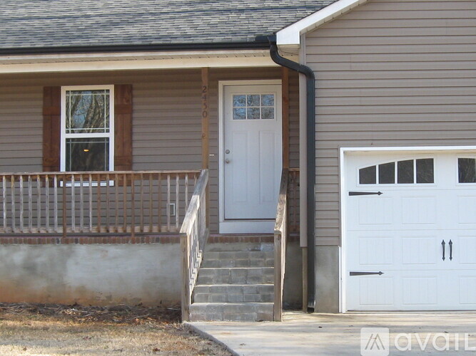 A house with a white door and a white garage door.