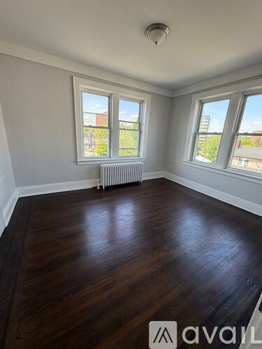 A room with wooden floors and white walls.