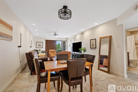 A dining room with a table and chairs.