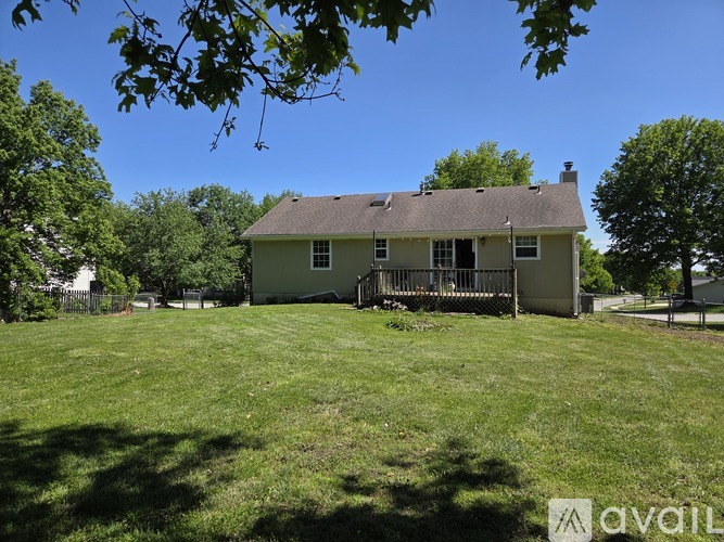 A house with a green lawn in front of it.