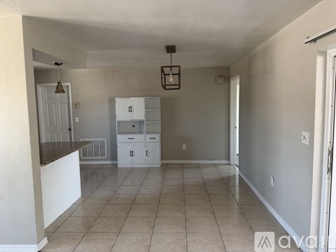 A kitchen area with a counter and cabinets.
