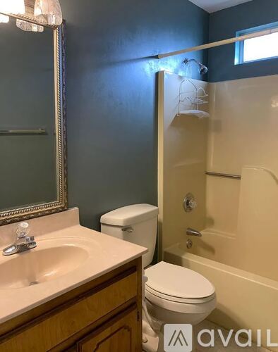 A bathroom with a toilet, sink, and bathtub.