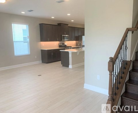 A kitchen with dark brown cabinets and a white island.