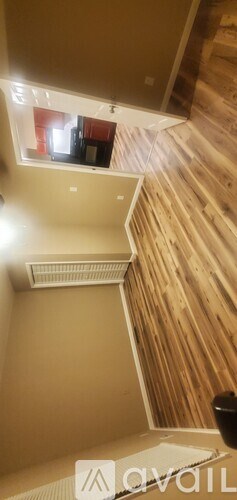 A wooden staircase with a skylight above it.
