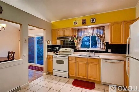 A kitchen with wooden cabinets and a white refrigerator.