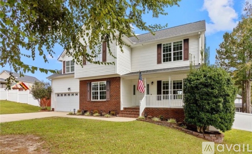 A house with a flag on the front porch is for sale.