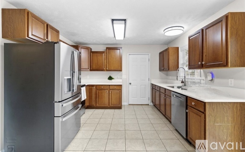 A kitchen with wooden cabinets and a refrigerator.
