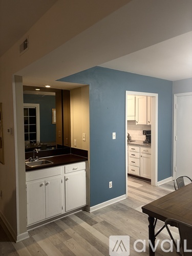 A kitchen with a table and chairs in the middle of the room.