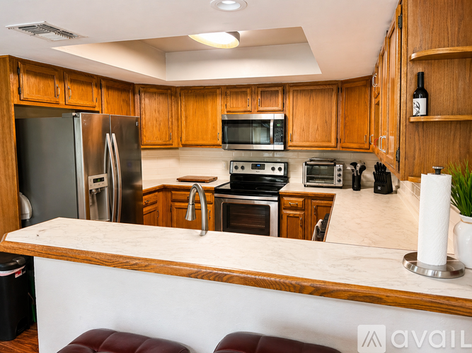 A kitchen with wooden cabinets and stainless steel appliances.