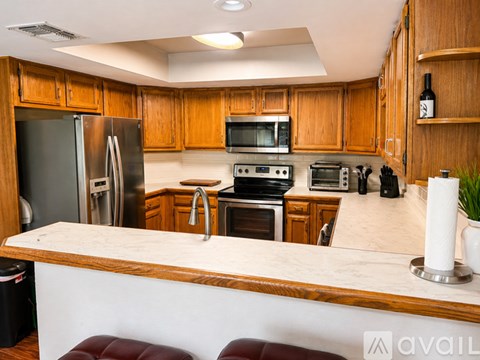 A kitchen with wooden cabinets and stainless steel appliances.