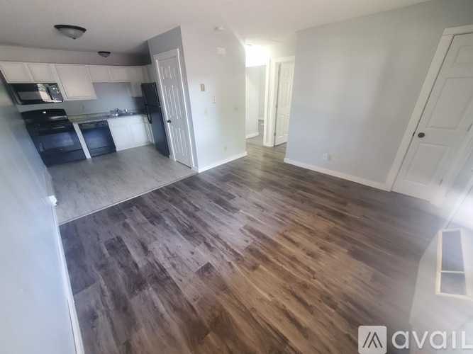 A kitchen with a refrigerator, oven, and microwave.