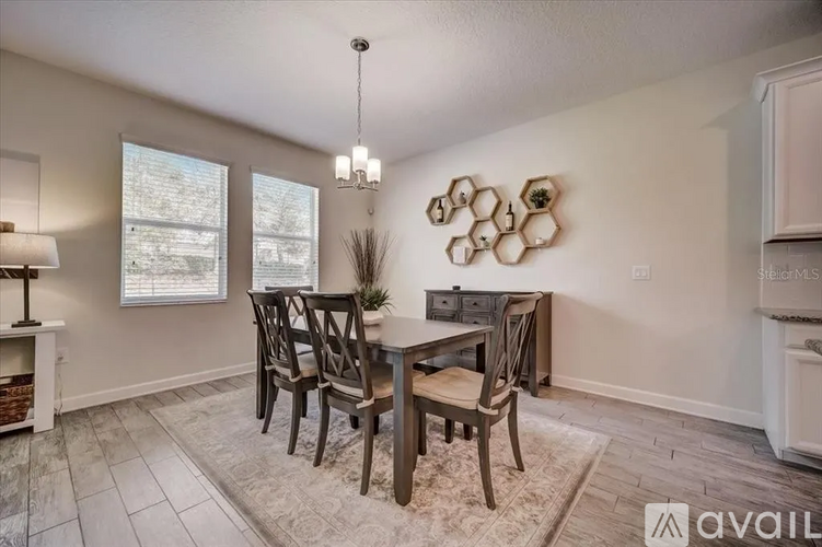 A dining room with a table set for four.